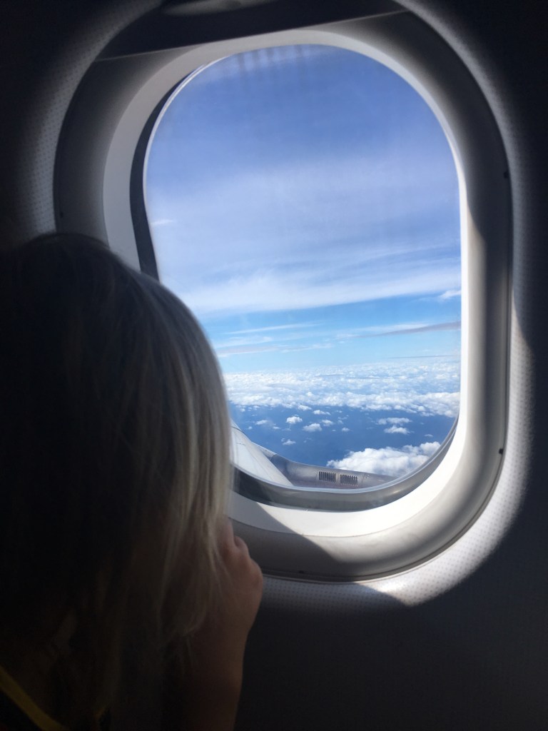 Middle man looking out window on arrival at Bangkok airport
